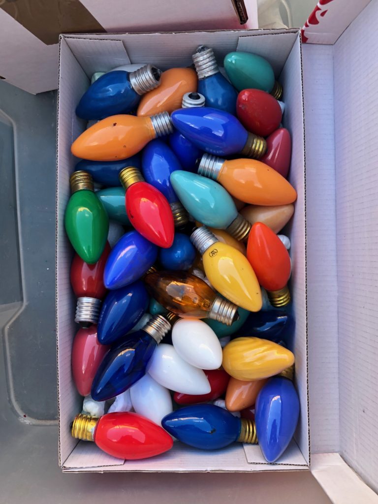 A box of lightbulbs of various colours.