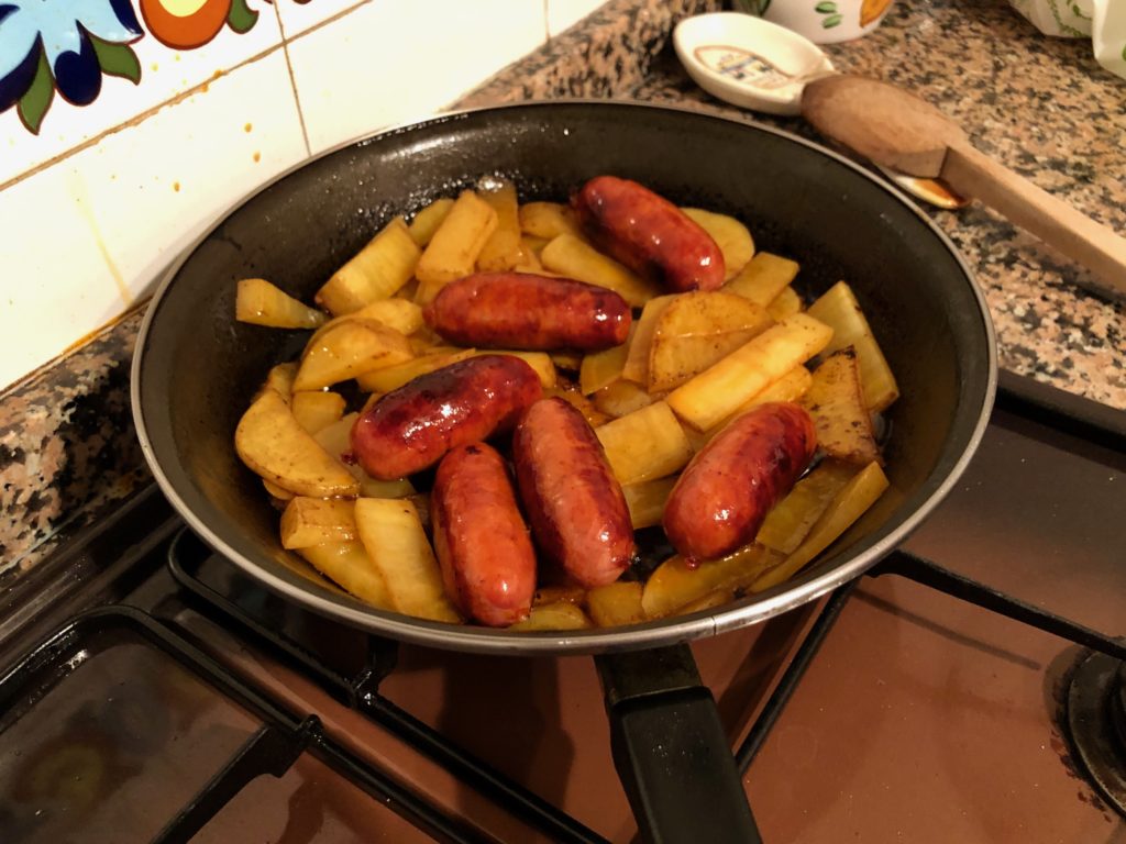 A frying pan full of chorizo and potato.