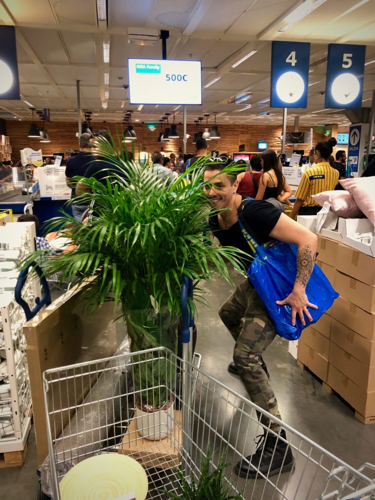 Bogar hides behind a large plant in IKEA.