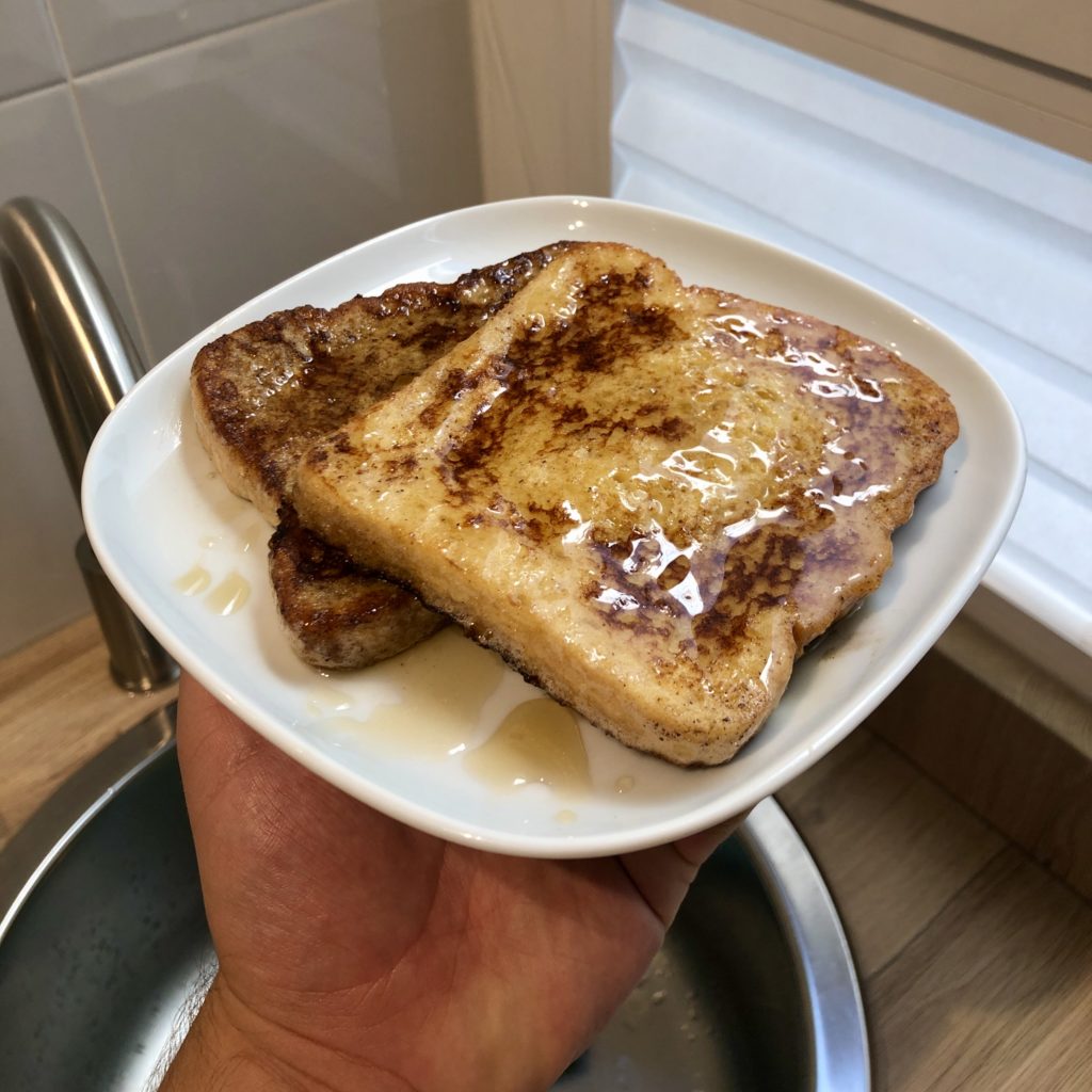 A plate of French toast with maple syrup.