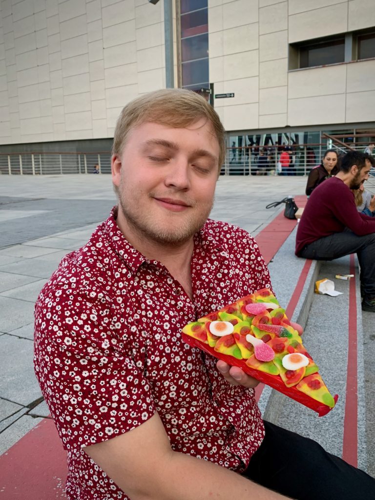I hold a slice of candy pizza.