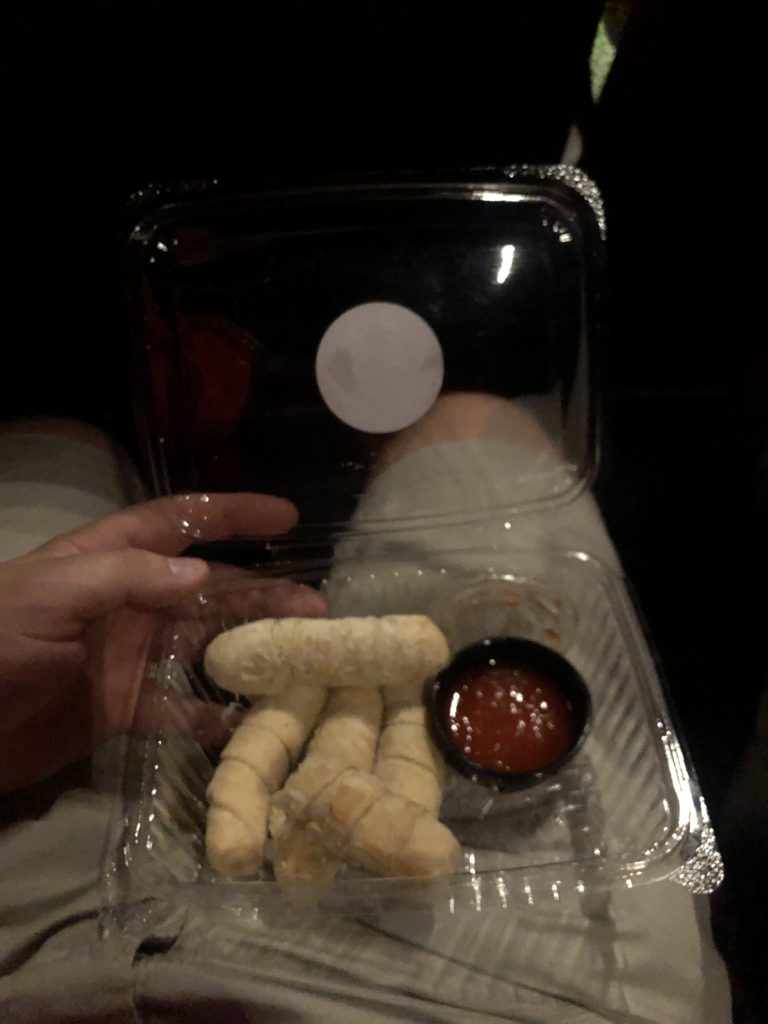 A box of cheese sticks in the cinema.