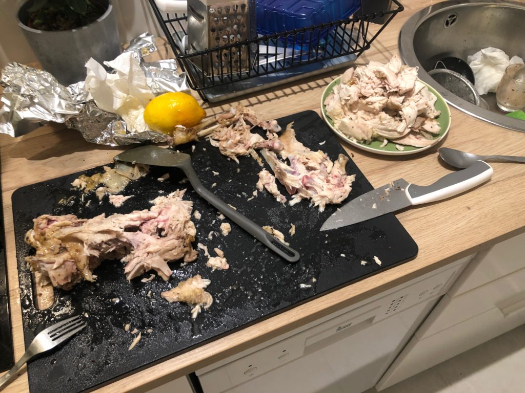 Chicken pieces lie all over the counter of my kitchen.