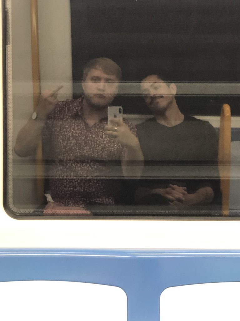 Me and Bogar in the reflection of a window on the metro.