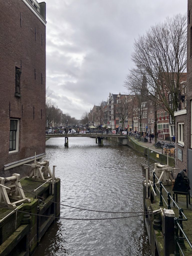 A canal winds through the streets of Amsterdam.