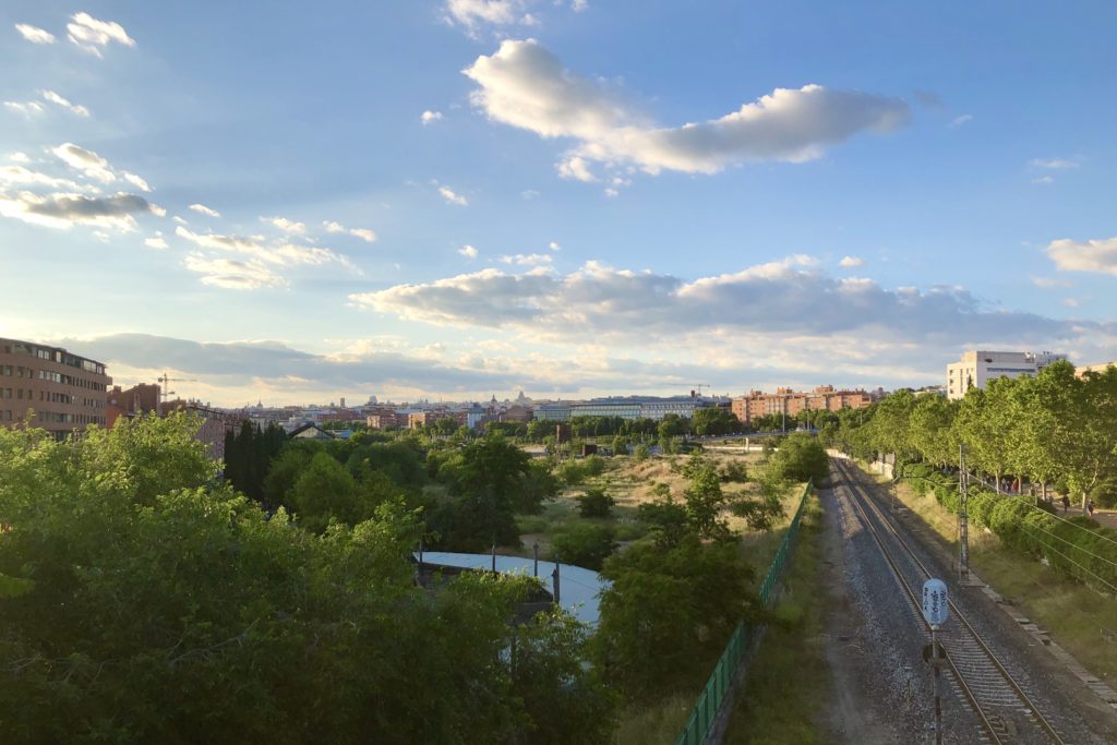 Clouds and blue sky over the city of Madrid as seen from a park in the south.