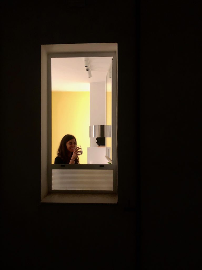Loredana framed by a window late at night.